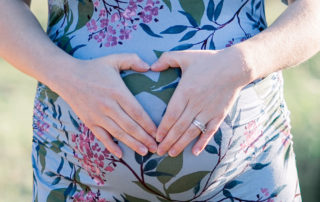 Hands over pregnant belly